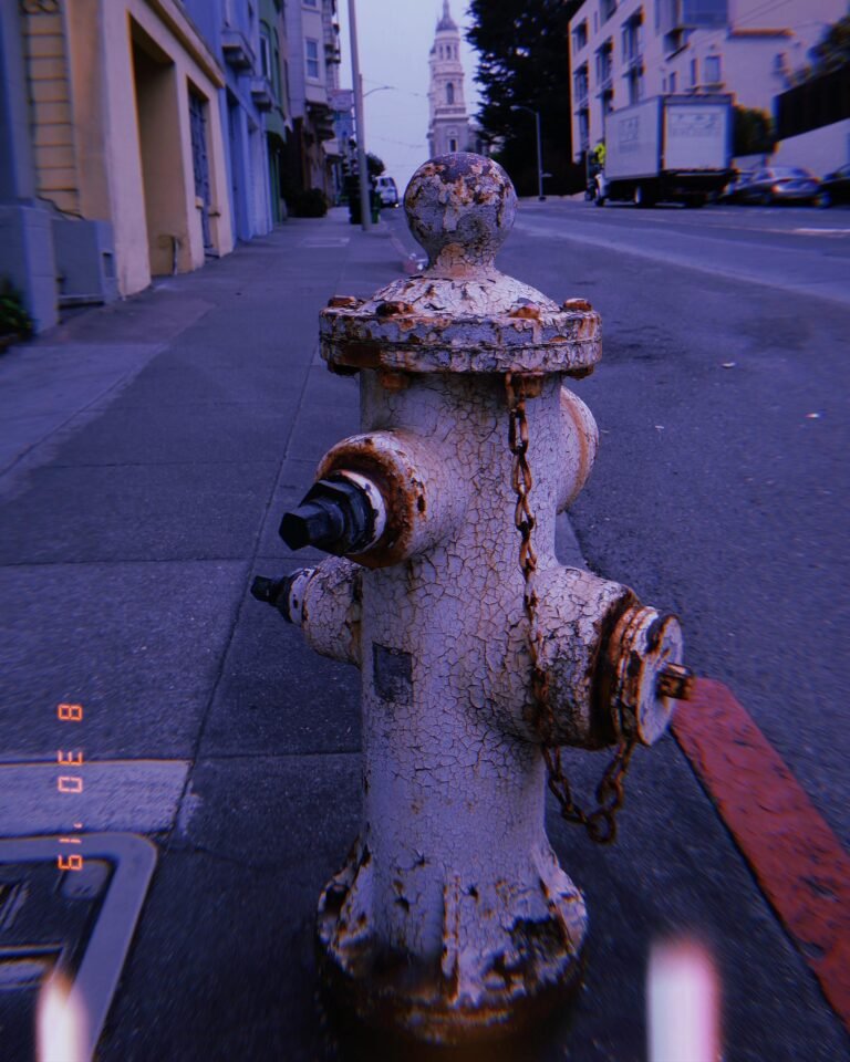 weathered fire hydrant on city sidewalk in San Francisco street