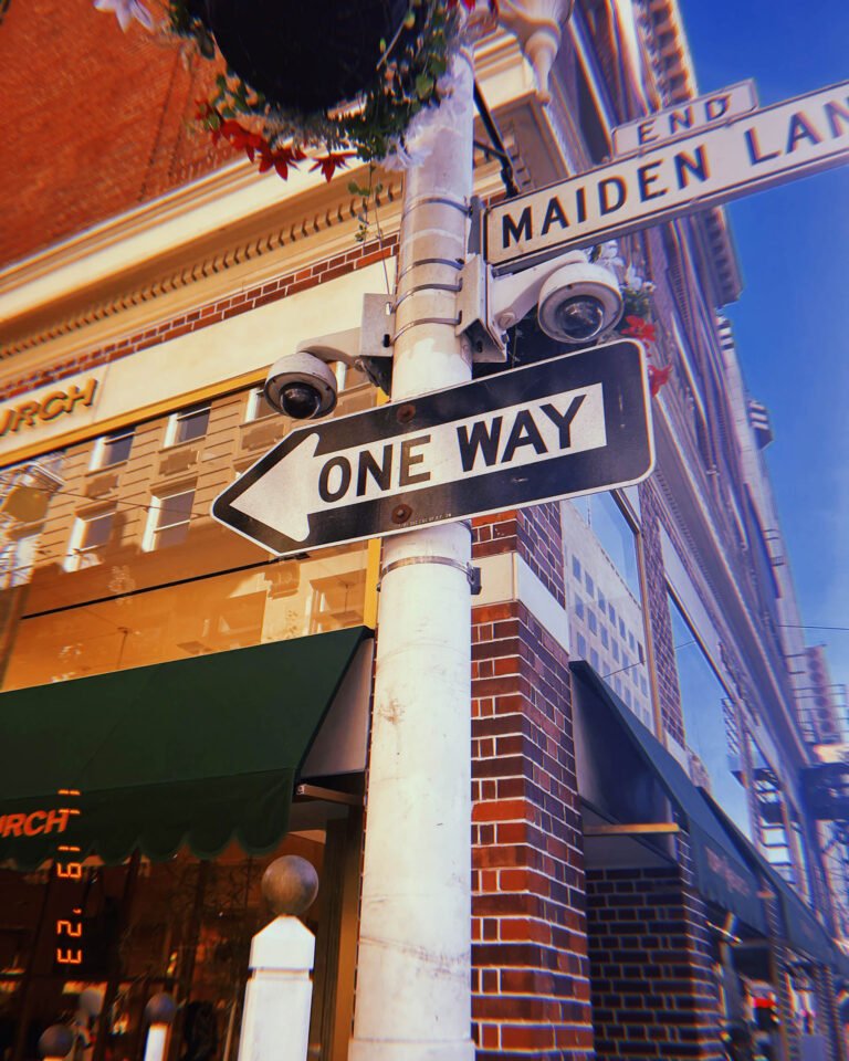 one way street sign and Maiden Lane street sign mounted on pole in San Francisco