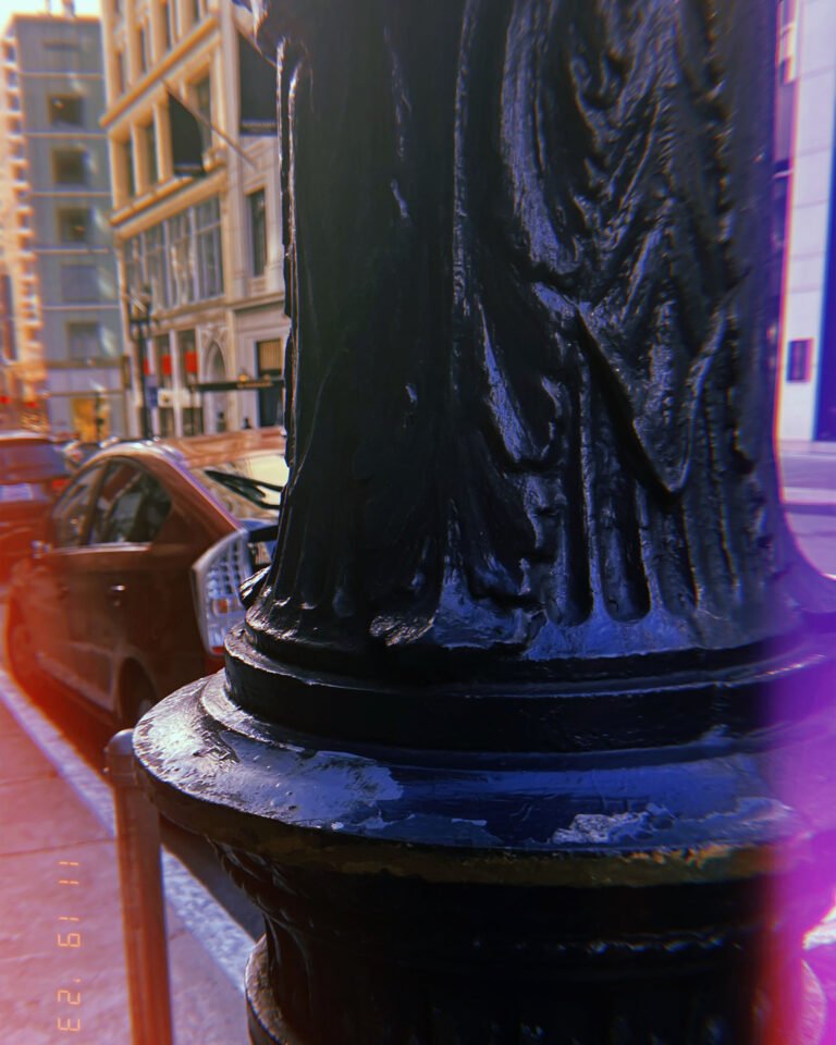 black cast iron street lamp base detail on city sidewalk in San Francisco