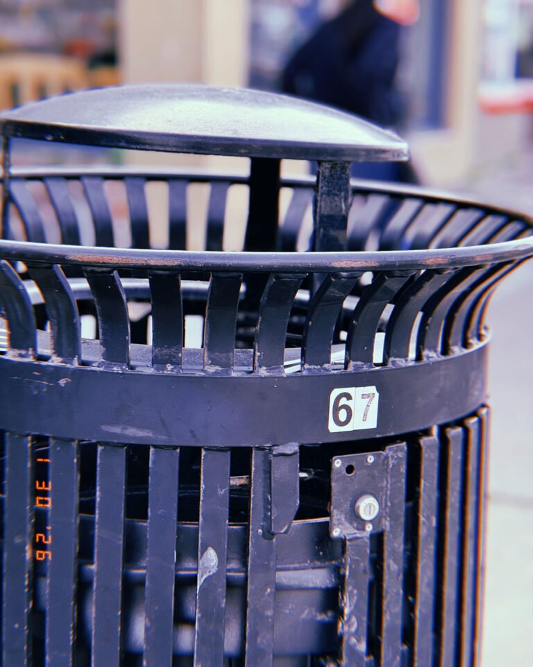 public trash receptacle installed on city sidewalk
