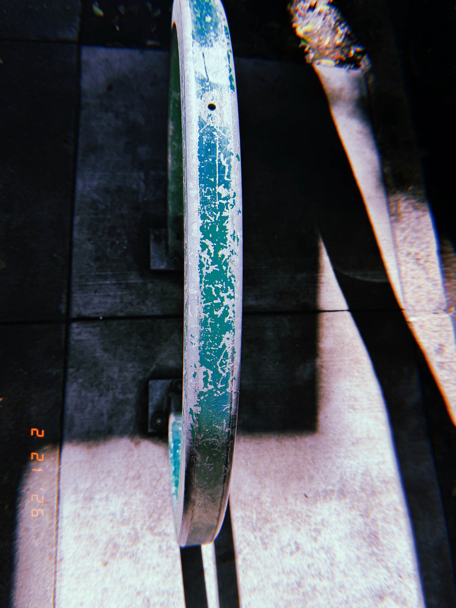 weathered circular metal door handle mounted on a public building entrance