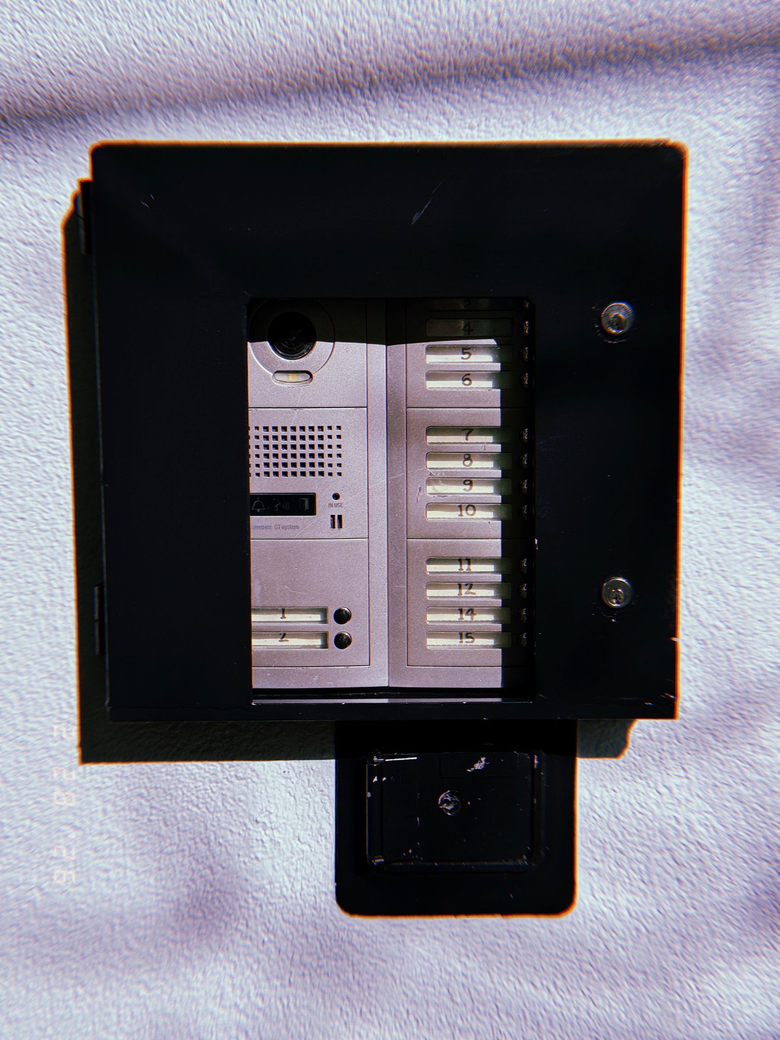 apartment building video intercom directory panel with numbered unit buttons