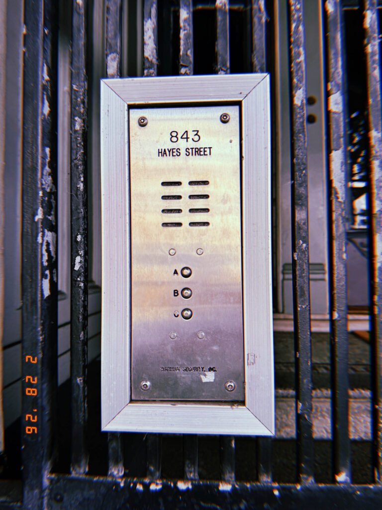 building entry intercom panel with address 843 Hayes Street mounted on metal gate