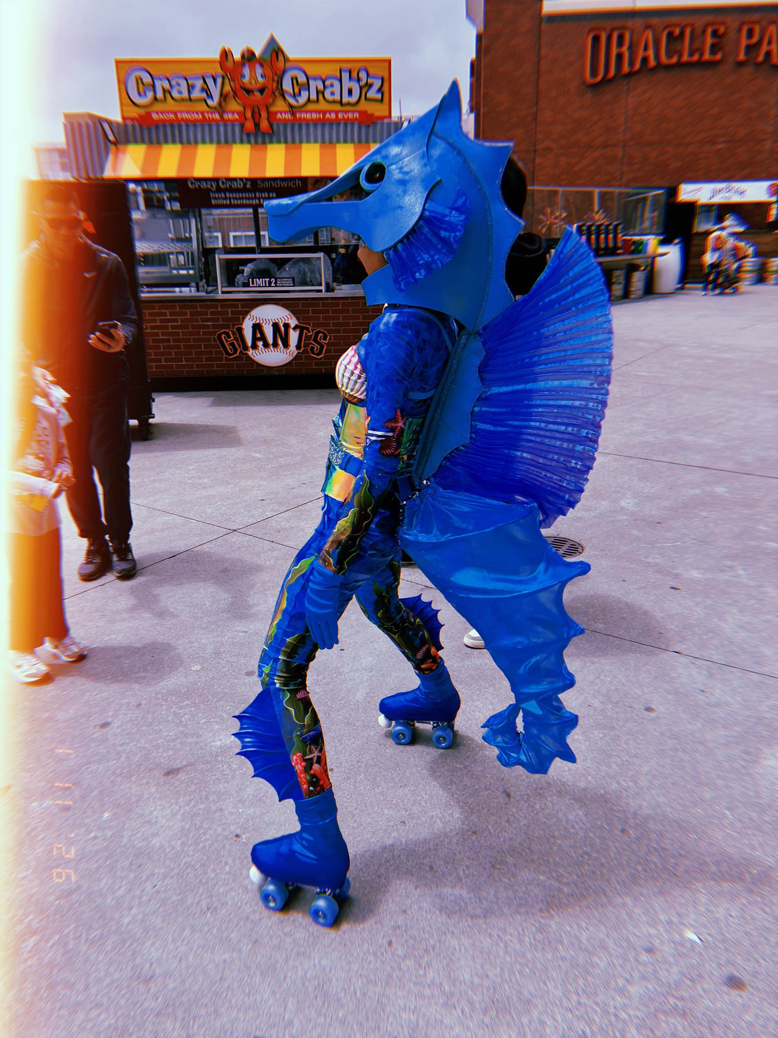 person in blue seahorse costume on roller skates outside Oracle Park in San Francisco