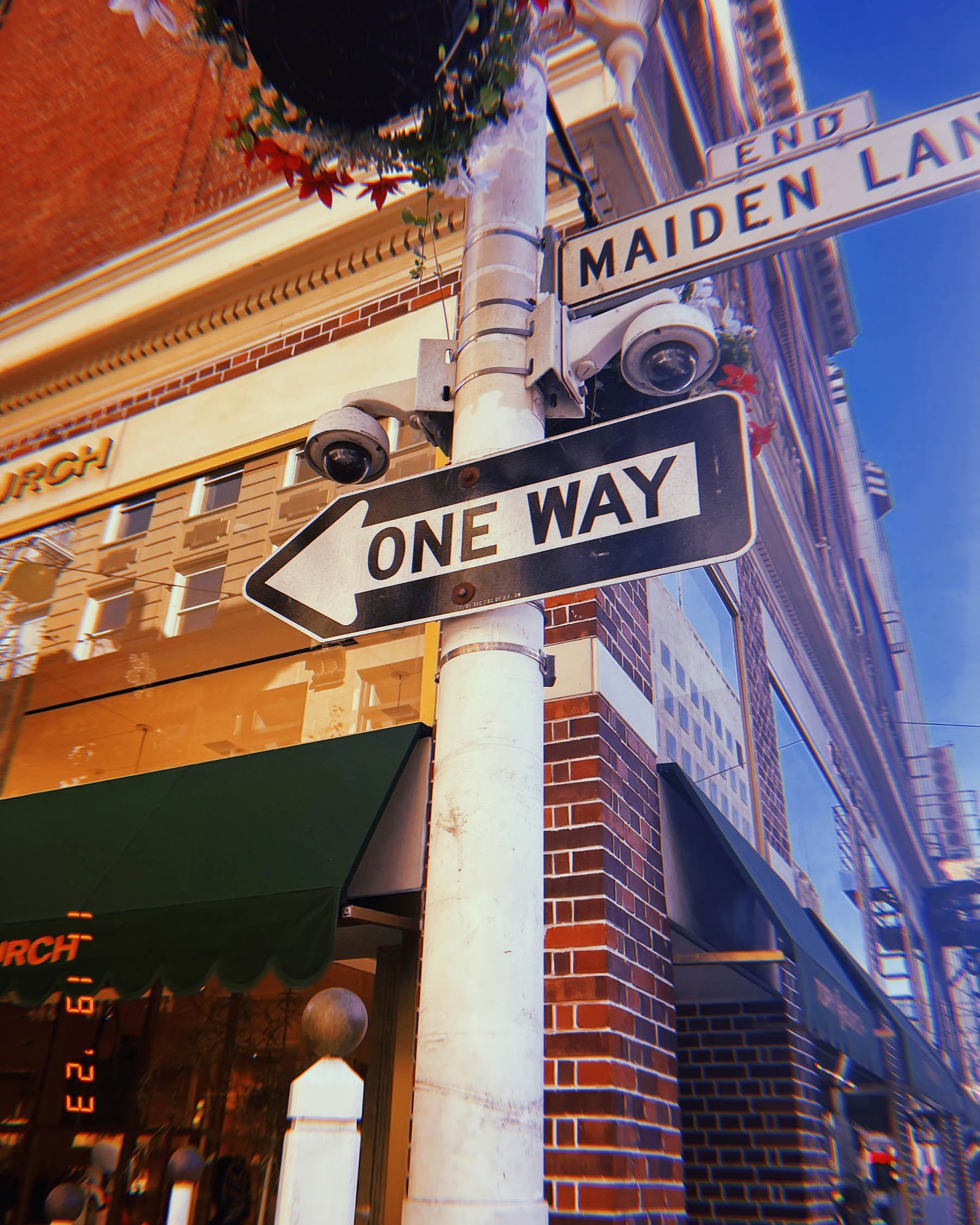 one way street sign and Maiden Lane street sign mounted on pole in San Francisco