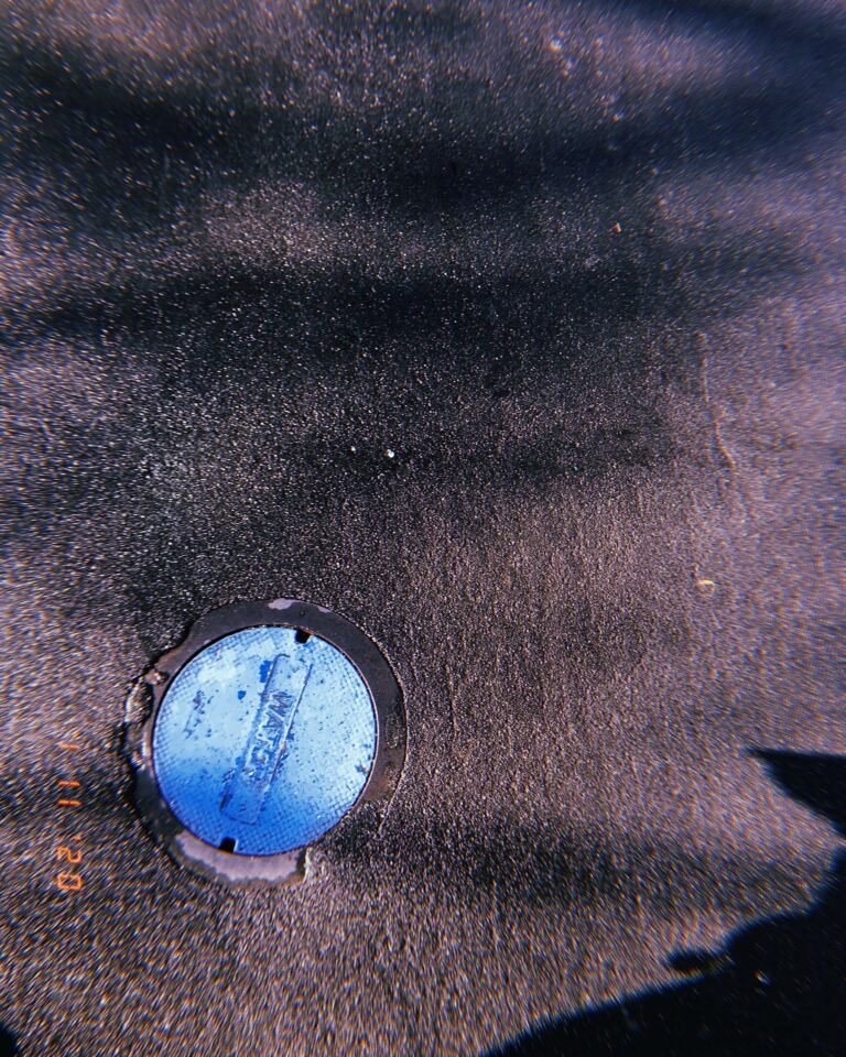 blue utility water cover embedded in asphalt surface in San Francisco