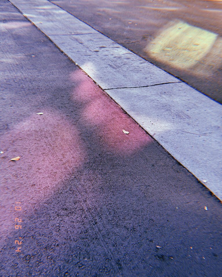 red painted curb line and concrete sidewalk edge on an asphalt street in San Francisco