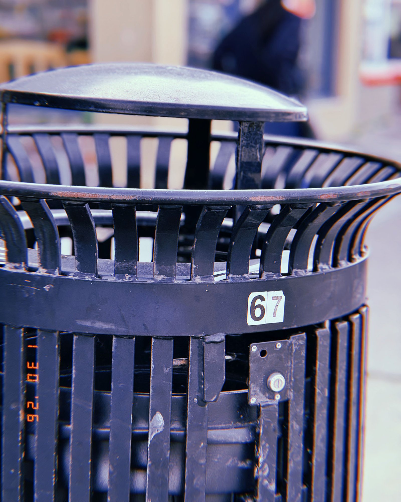 public trash receptacle installed on city sidewalk