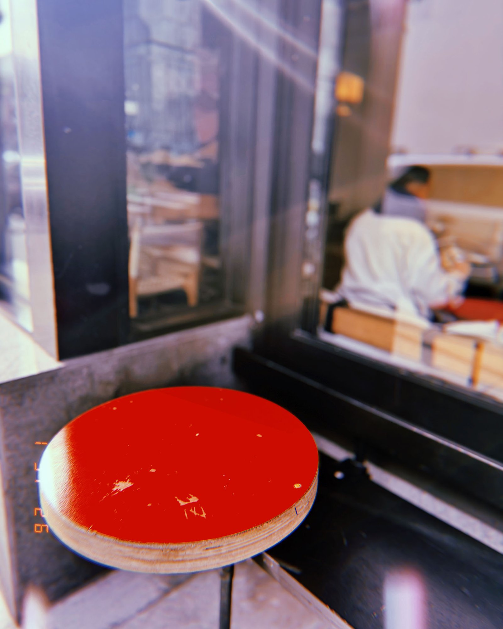 red service bell button mounted at restaurant takeout window