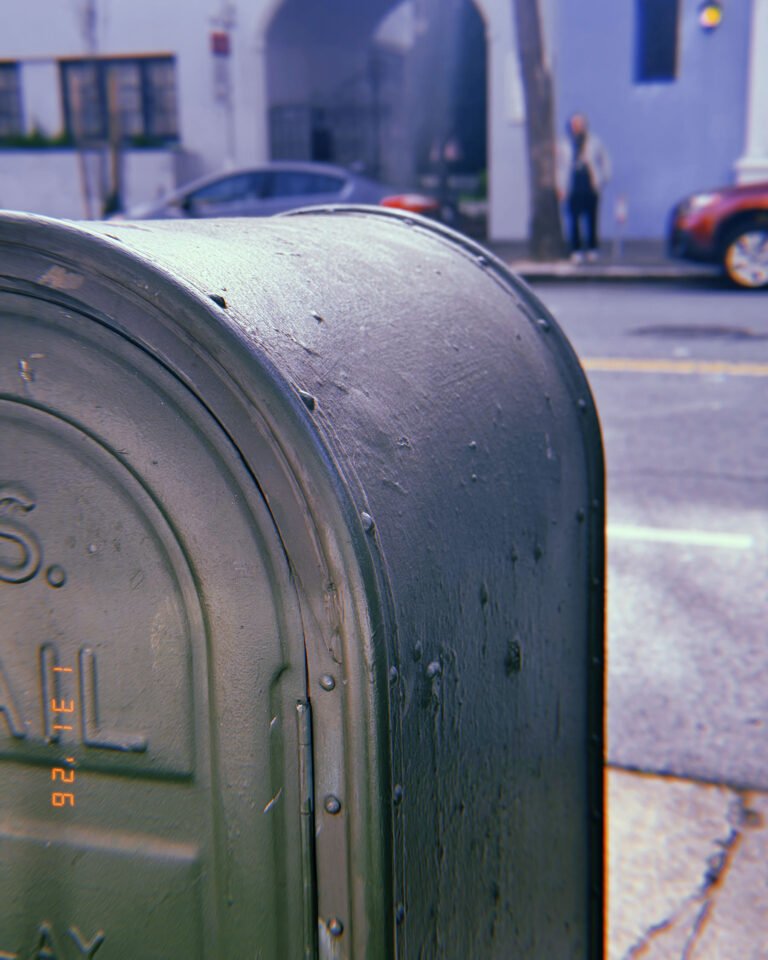 public mailbox installed on sidewalk along city street