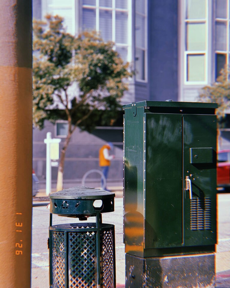 street utility cabinet installed beside public trash receptacle
