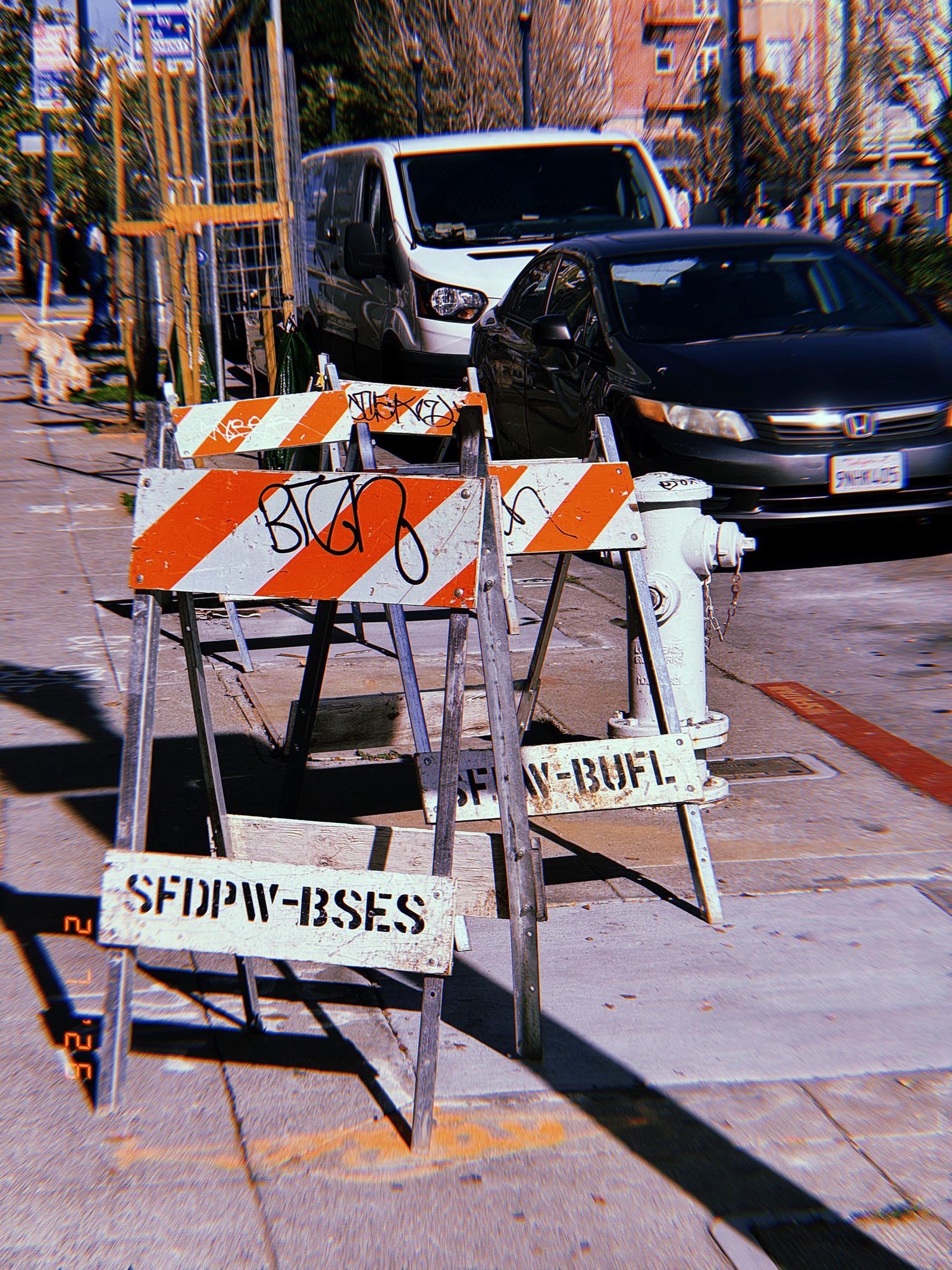 temporary street barricades placed along a city sidewalk