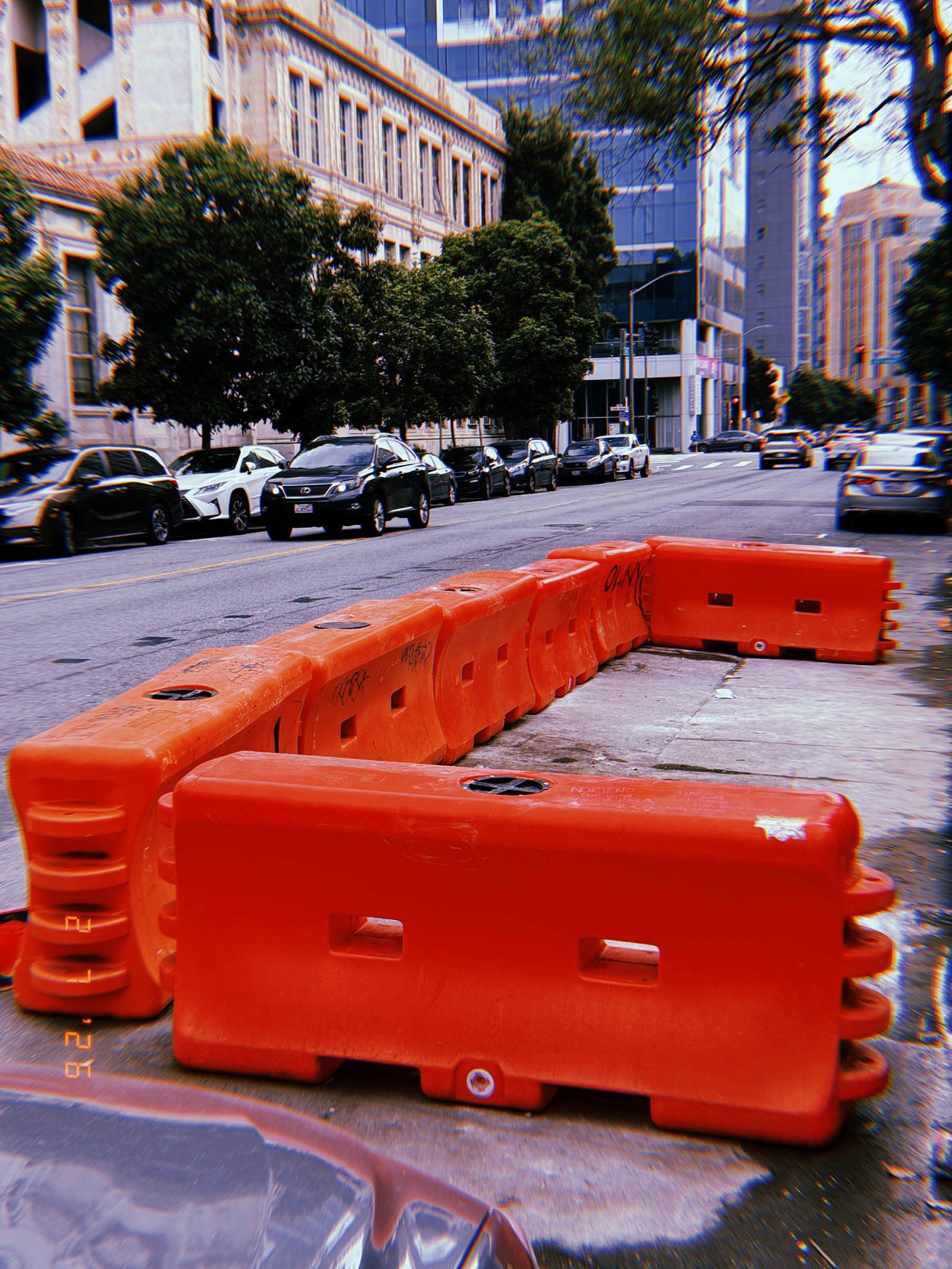 temporary construction barriers occupying part of the sidewalk and street
