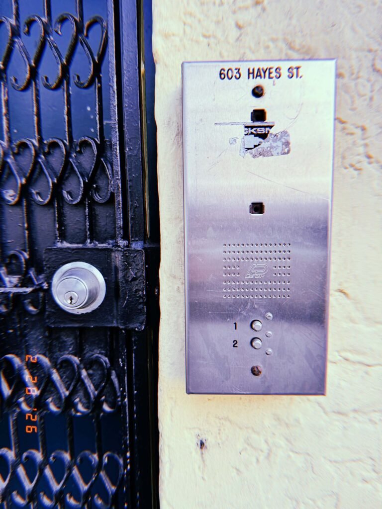 building entry intercom panel labeled 603 Hayes St mounted beside metal gate