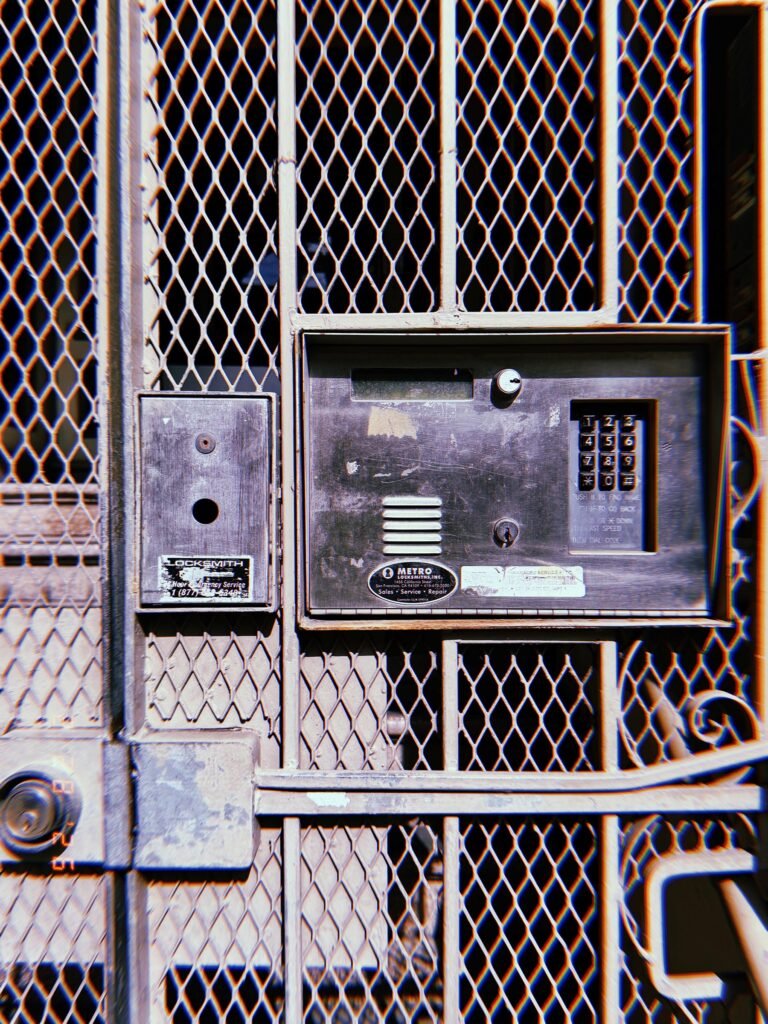 metal gate access control panel with keypad and intercom mounted on security gate