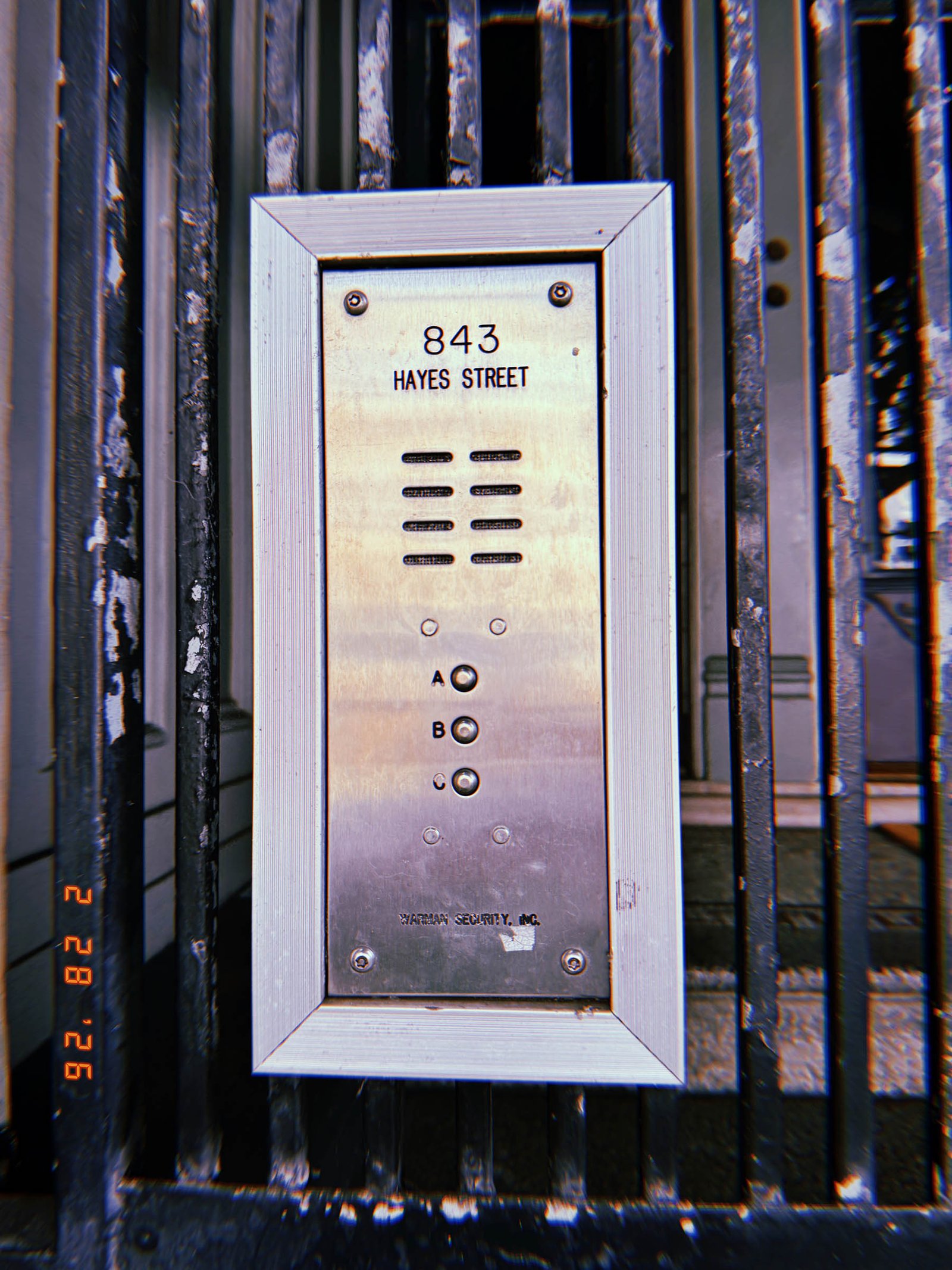 building entry intercom panel with address 843 Hayes Street mounted on metal gate
