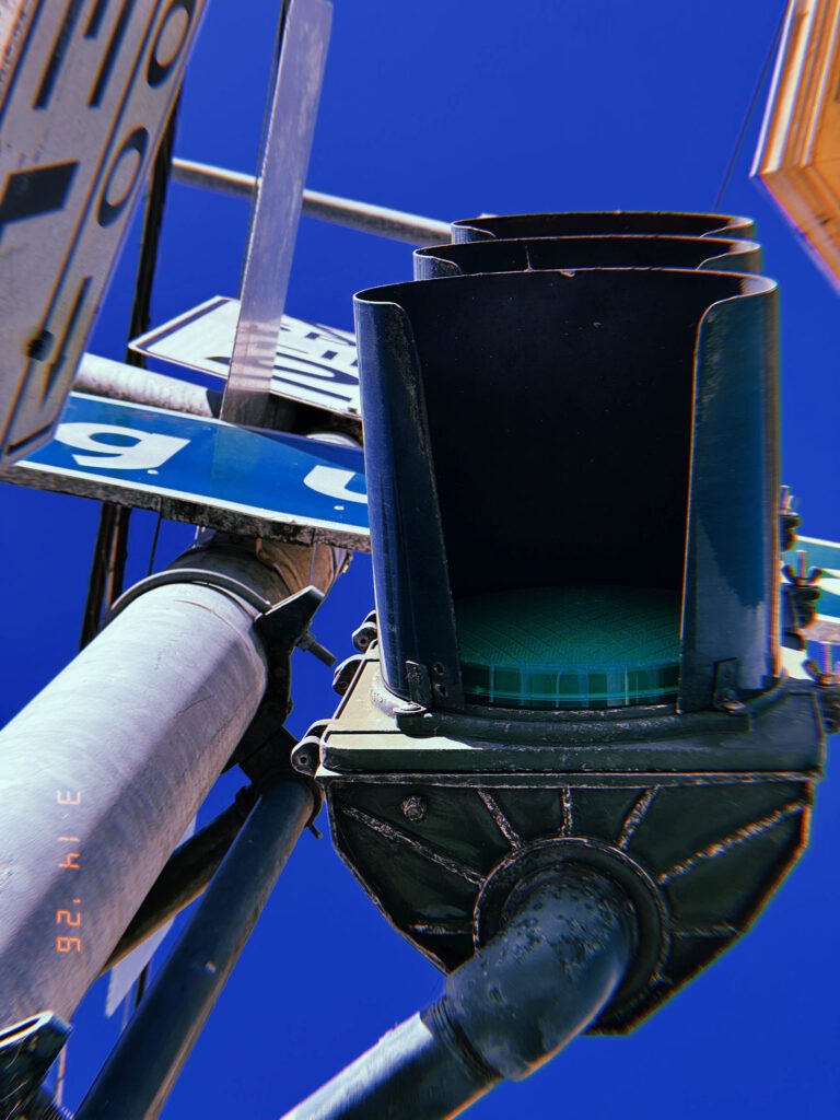 Green traffic signal directing movement within urban signal systems in San Francisco.