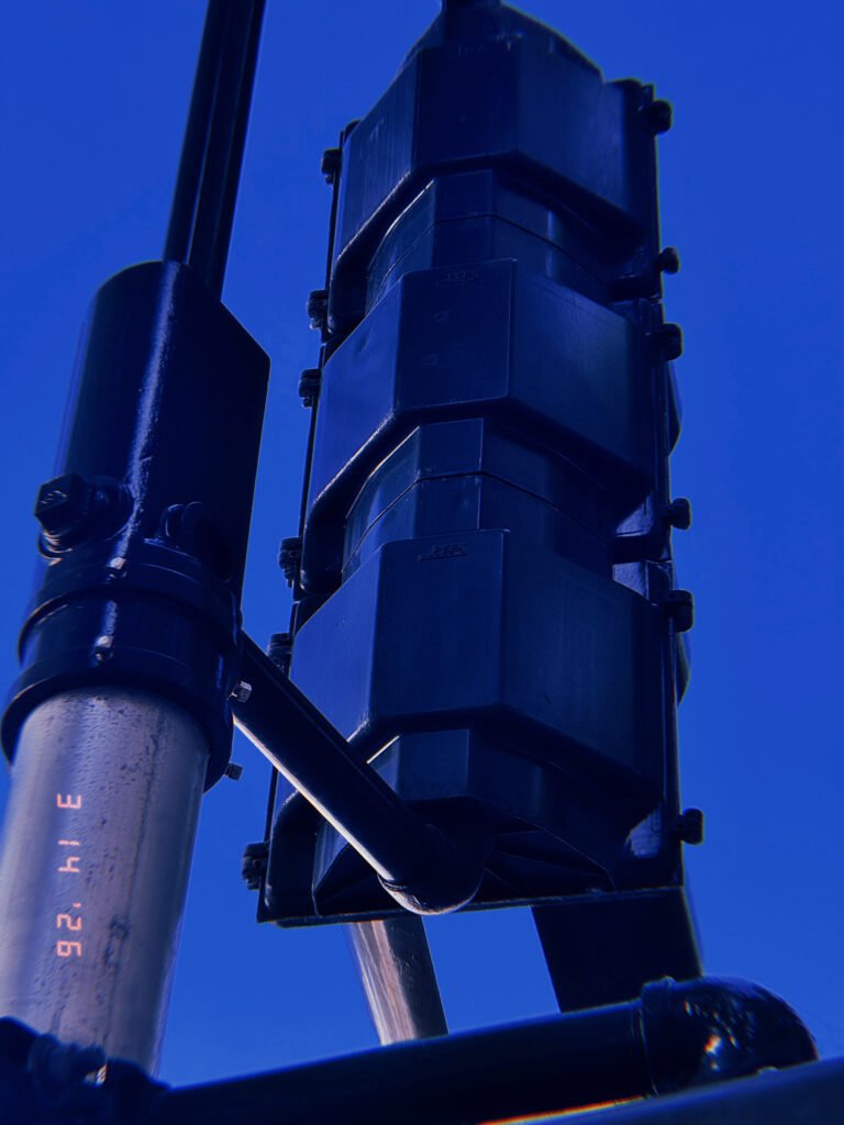 rear view of traffic signal housing mounted on pole with structural support