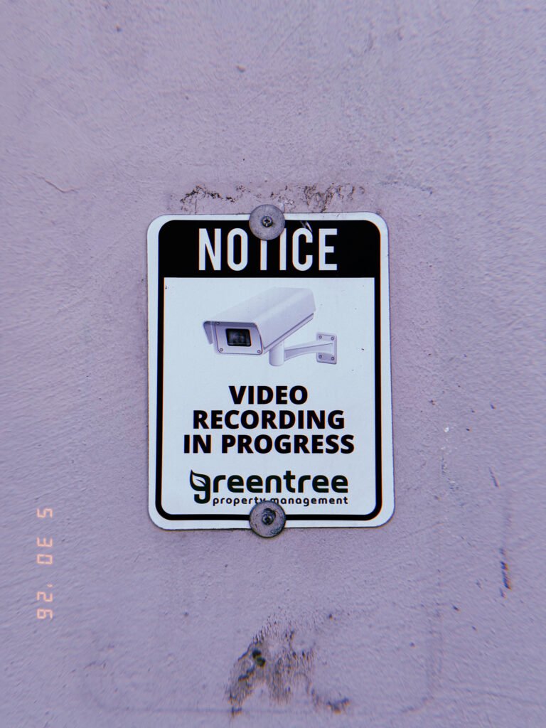 Notice sign stating video recording is in progress, with a surveillance camera graphic, mounted on a wall in San Francisco.