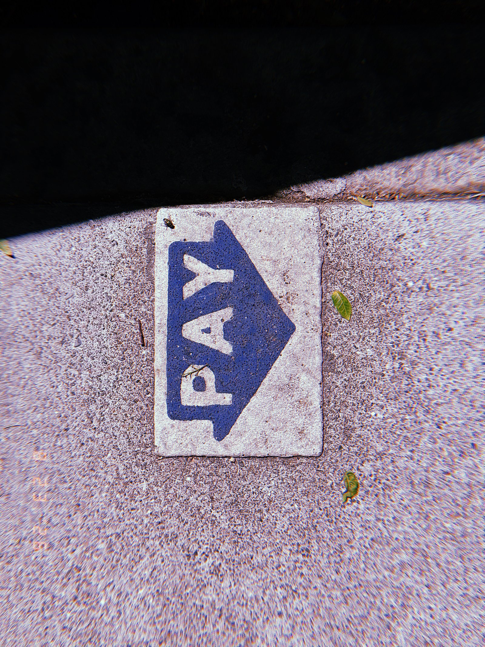 A worn field of raised tactile domes records repeated pedestrian contact while maintaining its function as a warning surface.